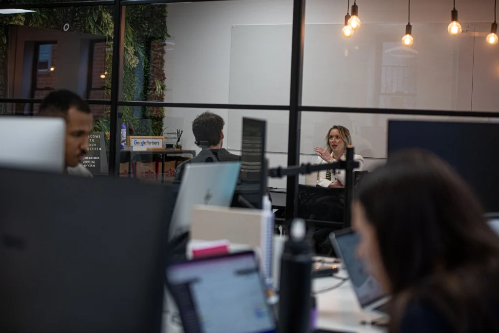 image of people working and in meetings in an agency office